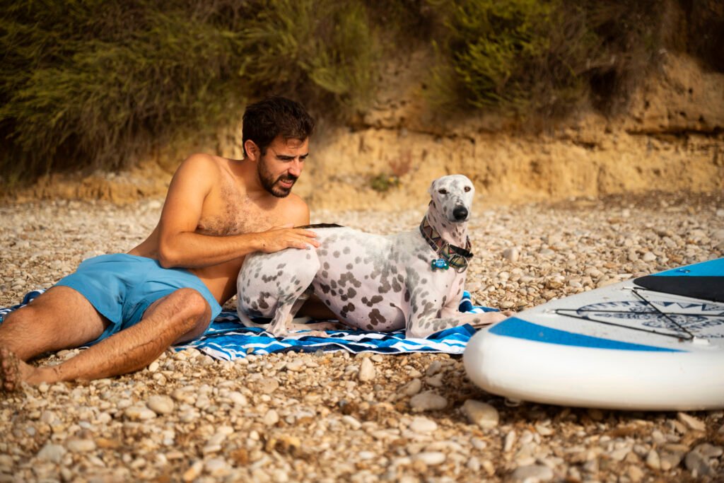 image of a man with the happy dog on vacations